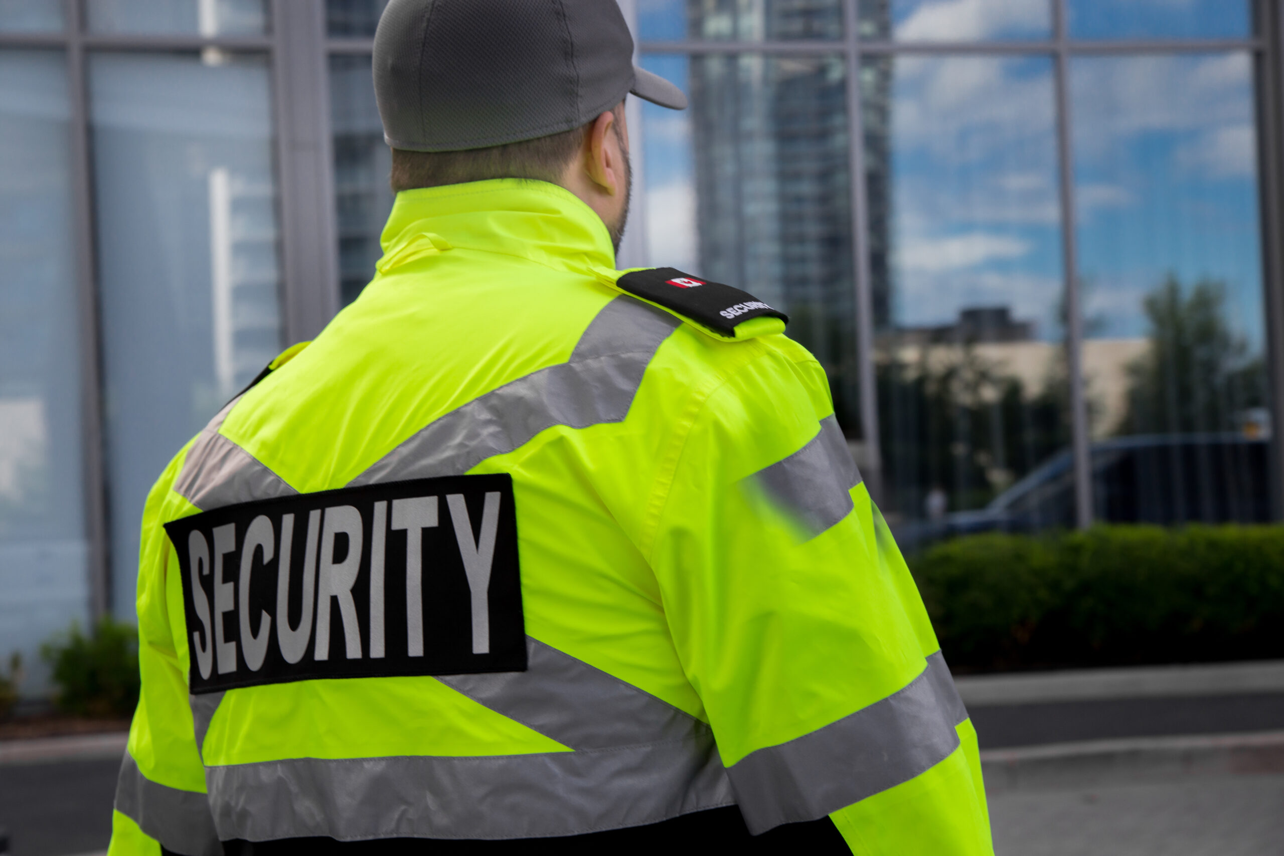 A security guard in uniform patrolling a residential area.